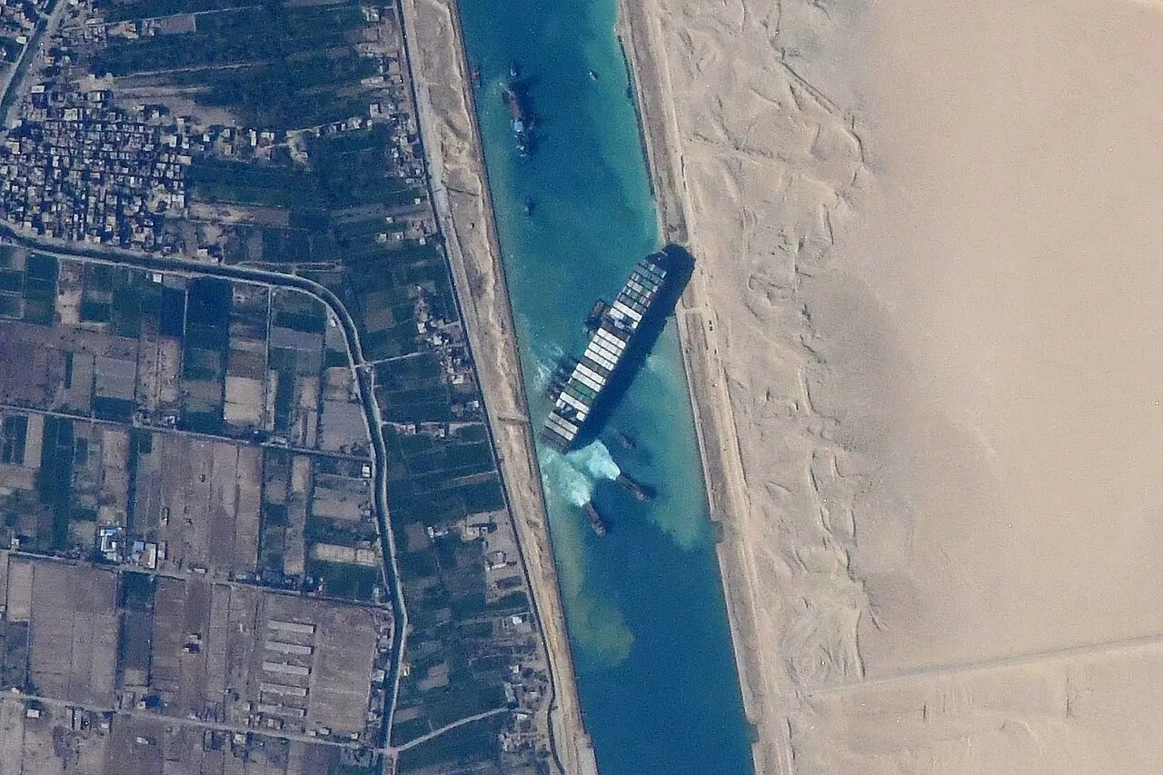 A container ship lodged across the Suez Canal, seen from orbit